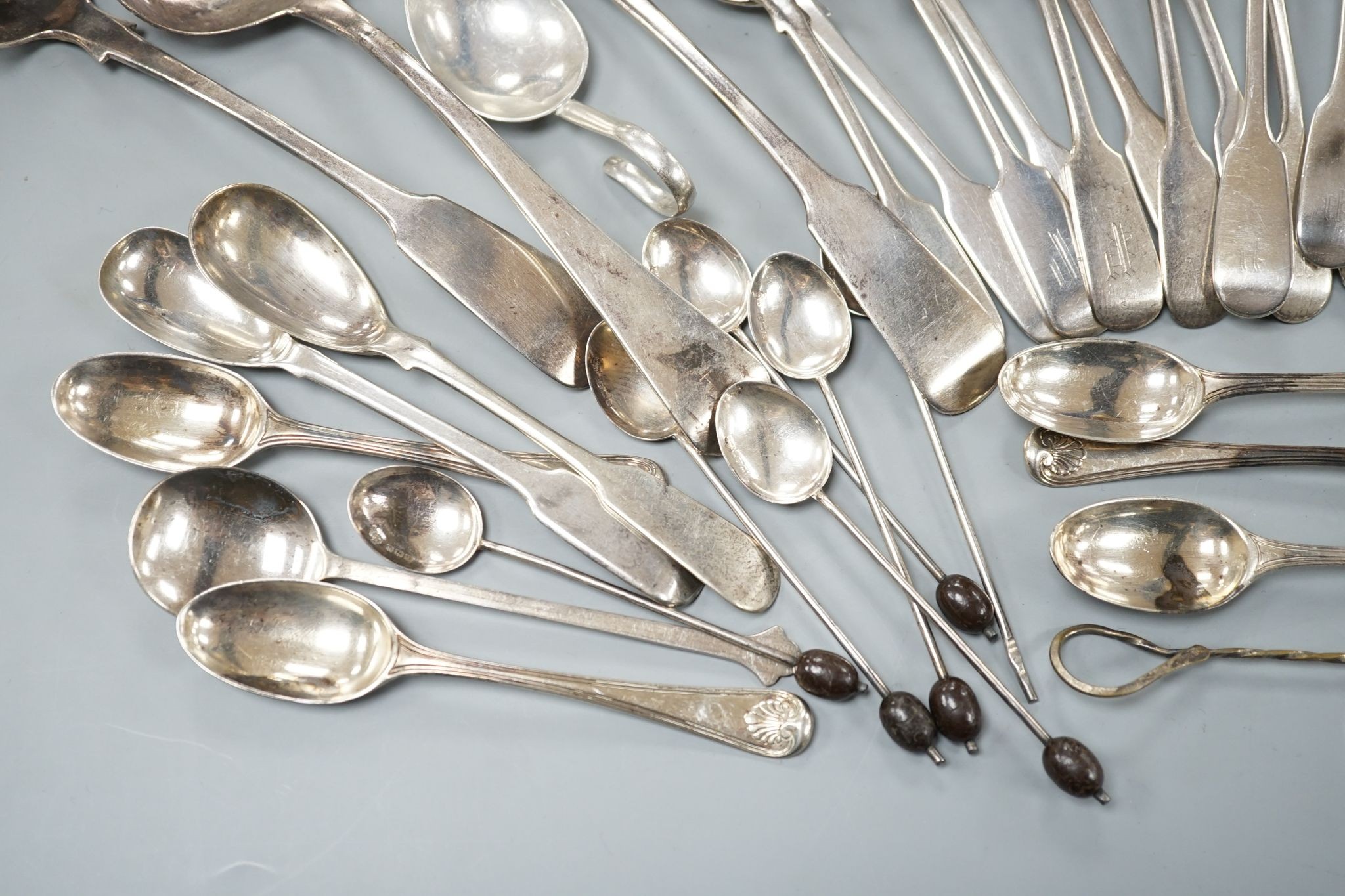 A set of twelve Victorian silver fiddle pattern teaspoons, London, 1870, a pair of Victorian sauce lades and a quantity of assorted sundry silver flatware